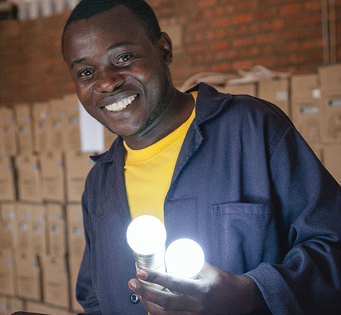 A man holds shining lightbulbs.