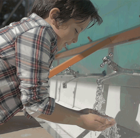 GIF of boy at a sink with running water