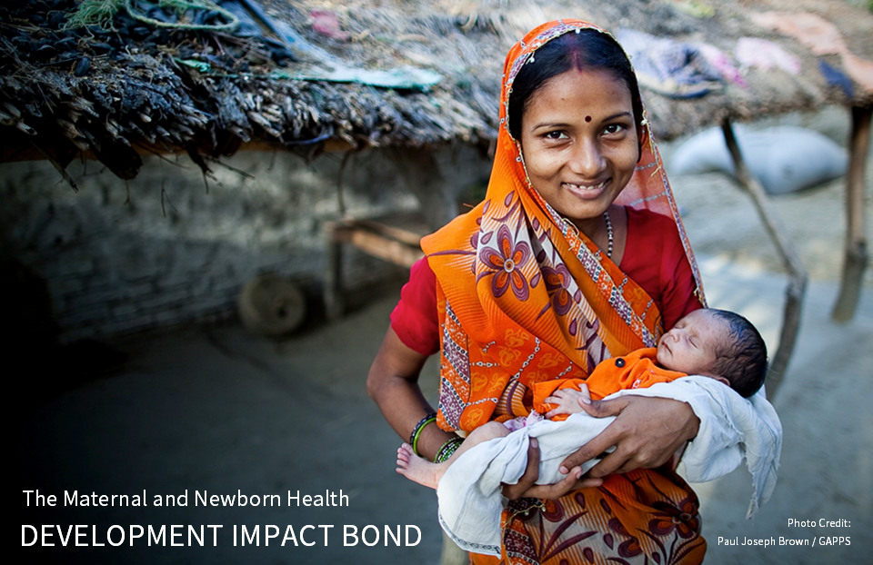 A smiling women from India holds her baby - Text Overlay: The Maternal and Newborn Health Development Impact Bond. Photo Credit: Paul Joseph Brown / GAPPS