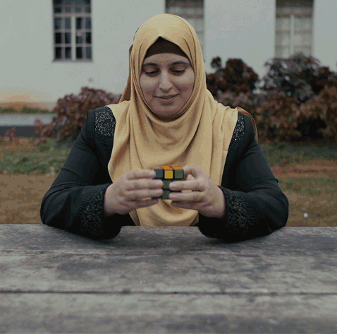 GIF of woman playing with a Rubik's cube