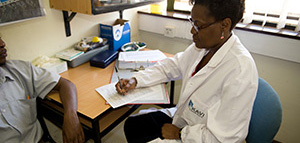  Photo of a clinician at the Kenya AIDS Vaccine Initiative collecting data