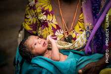 A mother holds an infant