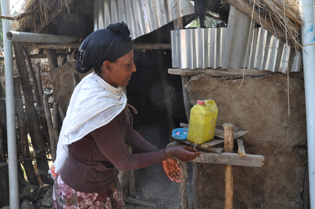 A woman practices safe hand washing in Ethiopia.