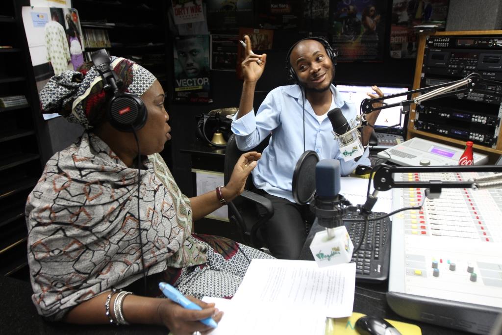 Radio anchor Oche discusses issues with a family planning expert, Mariam Momoh, during a live program about family planning on Wazobia FM in Abuja, Nigeria