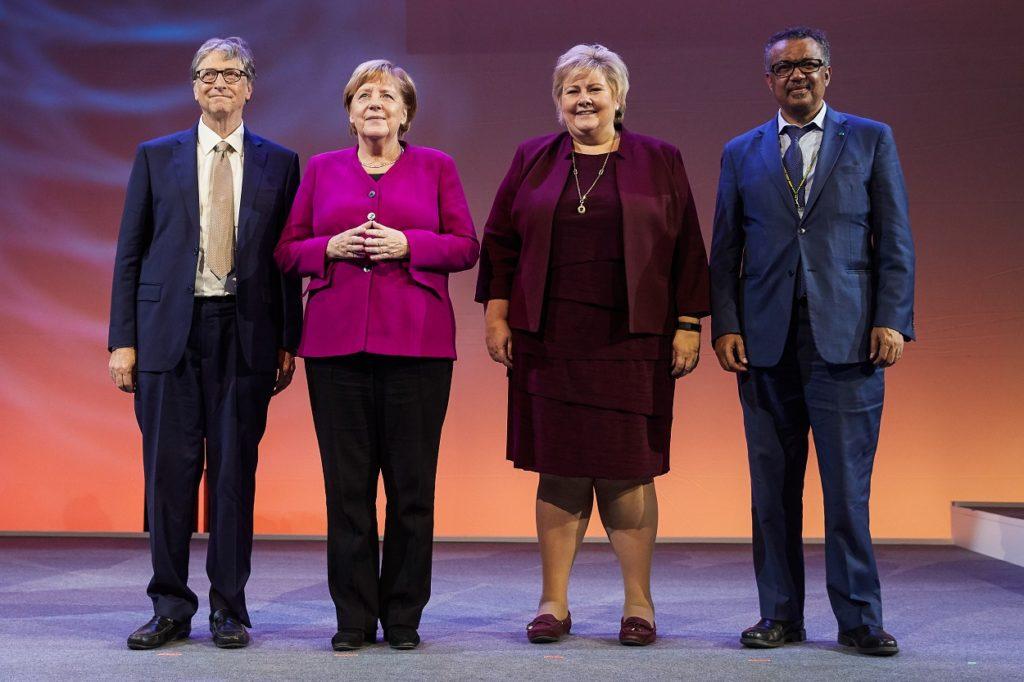 Photograph of Bill Gates, Angela Merkel, Dr. Ghebreyesus, and more at the Grand Challenges Meeting.