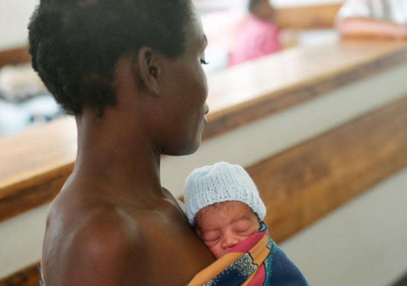 A woman holds her premature infant.