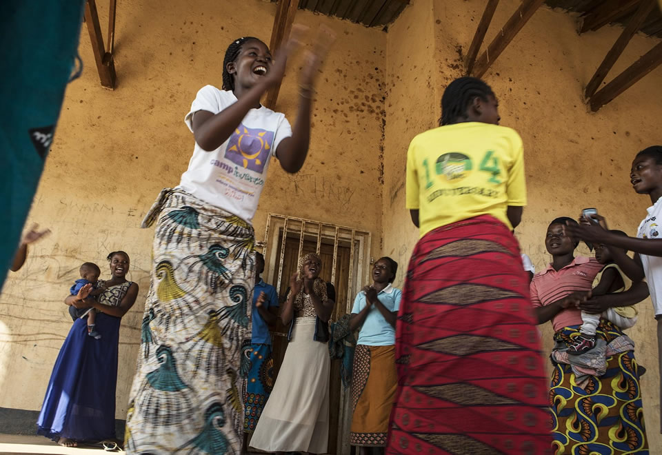 Two young women dance during an event for the DREAMS partnership.