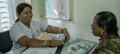 Shanta Das, a paramedic at Smiling Sun Clinic, consults with patients.