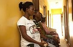 Quality, Equity, Dignity Network. Photo of a pregnant woman in a clinic.