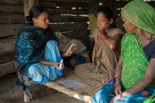 A woman provides instruction on the use of antiseptic gel in Nepal