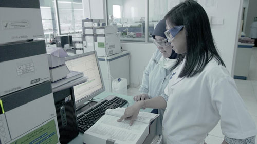 A researcher examines safe medicines.