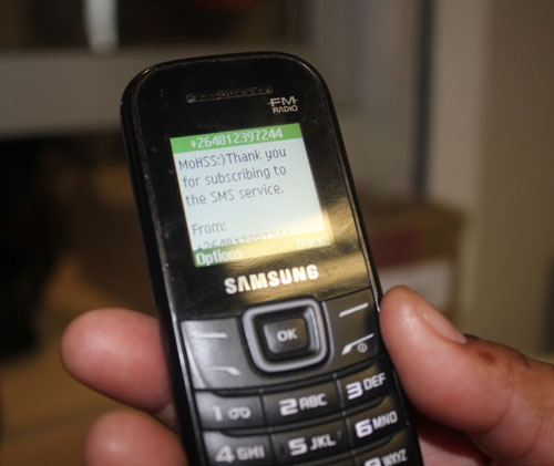 A digital phone showing a text message in the screen.
