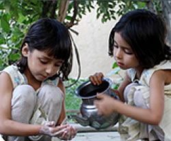 Women as Behavior Change Agents for Gaining Equity. Photo of two young girls playing.