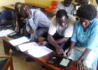 A Yumbe survey team learns how to use electronic tablets to collect data on trachoma.