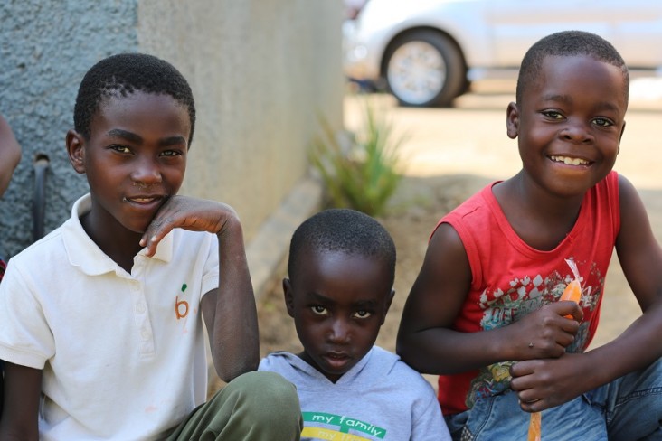 Three young boys  during a USAID handover ceremony in Kabwe.