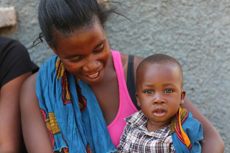 A mother and son attend a USAID handover ceremony in Kabwe.