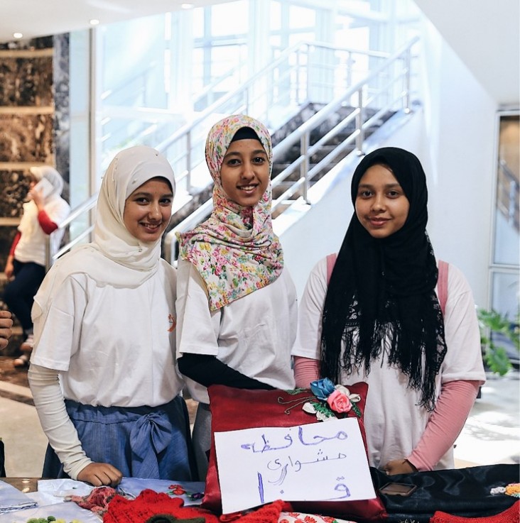 Girls from Upper Egypt sell hand-made projects at a youth conference.