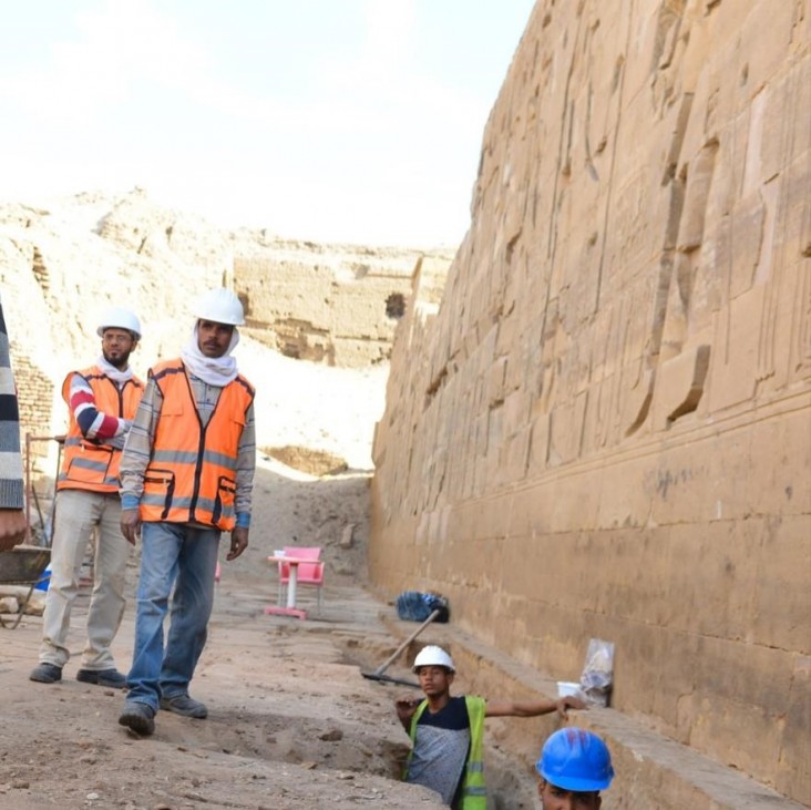 Workers dig a trench at Kom Ombo Temple in Aswan, Egypt