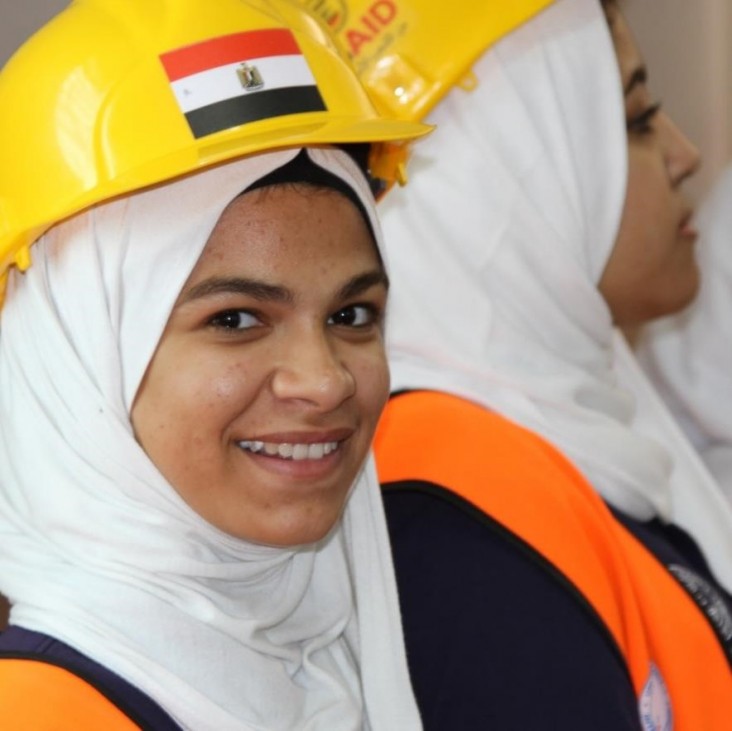 A vocational school student wearing a hardhat at school