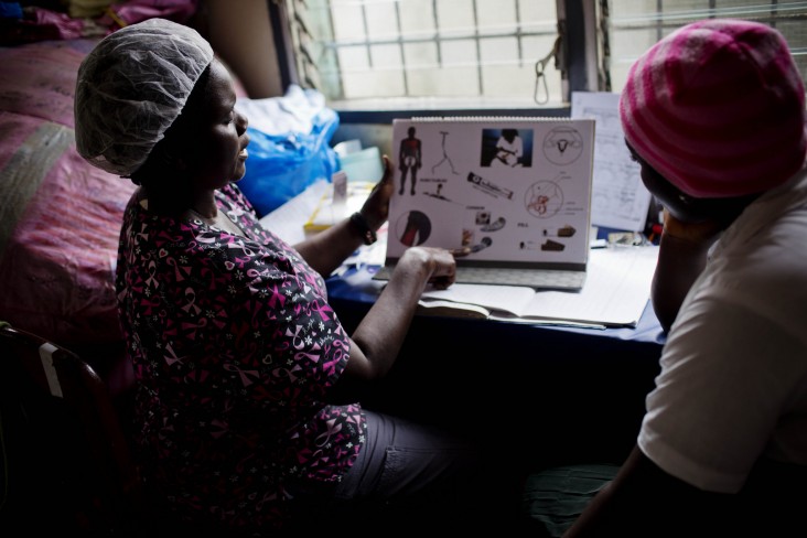 A midwife examining a patient in Liberia