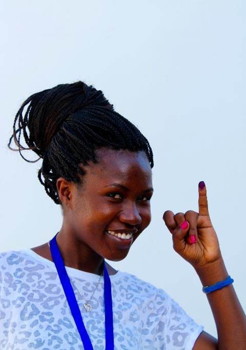A girl shows her finger after voting in a Zambian election