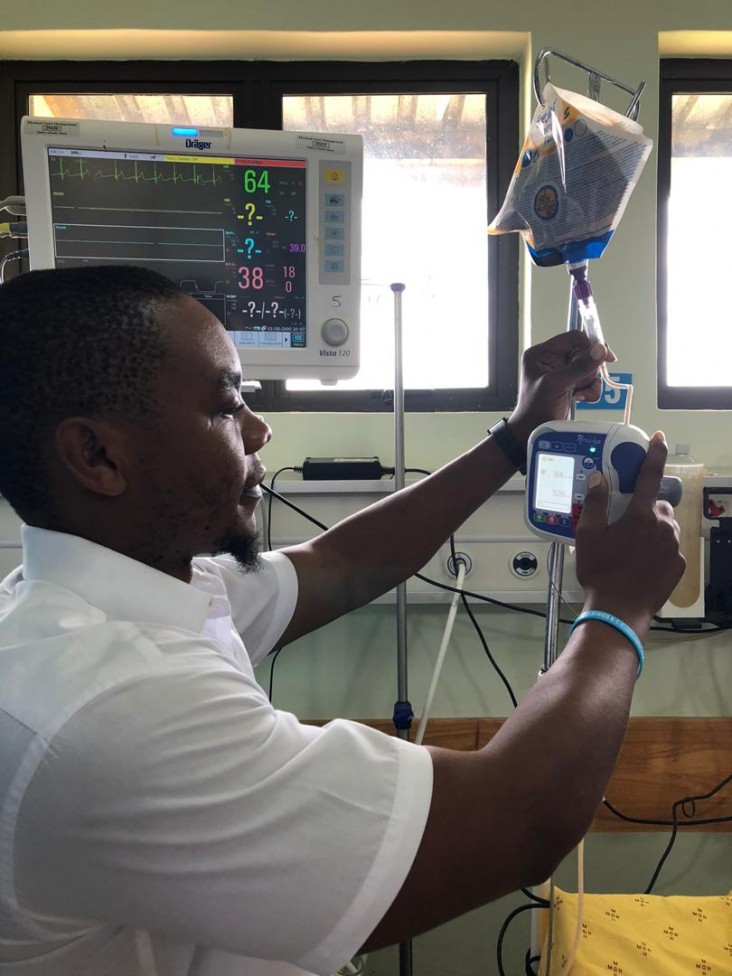 Registered dietitian Jonathan Misolo installs a feeding pump in an intensive care unit in Lilongwe.