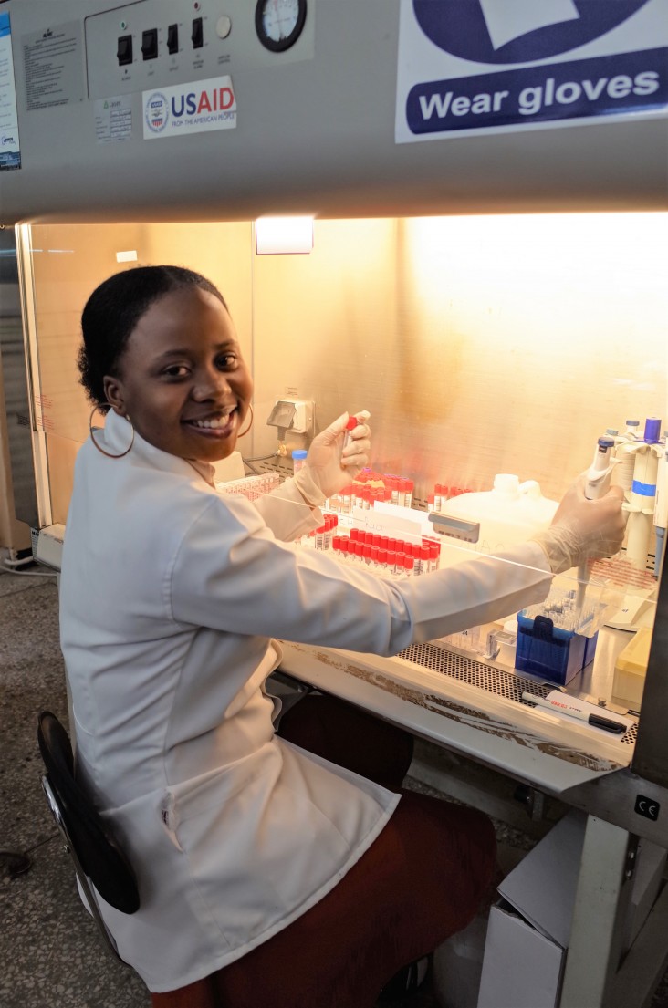 A lab technician uses USAID-funded equipment to test HIV viral loads in Zambia.