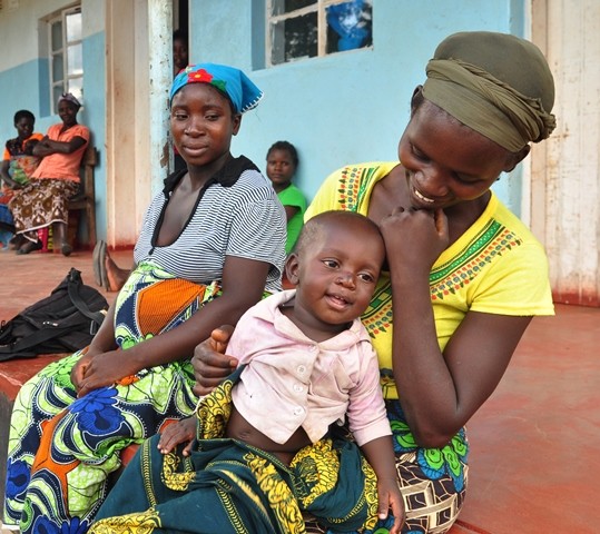Photo is of a Zambian mother and her child at a rural clinic supported by USAID.