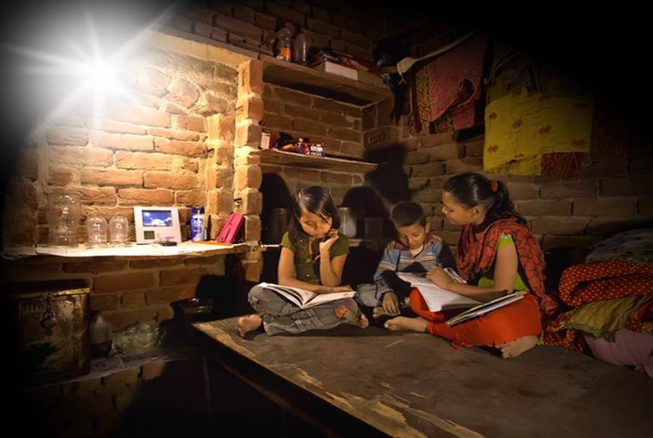 Picture of household reading at night thanks to Simpa Networks' Lights for Education program 