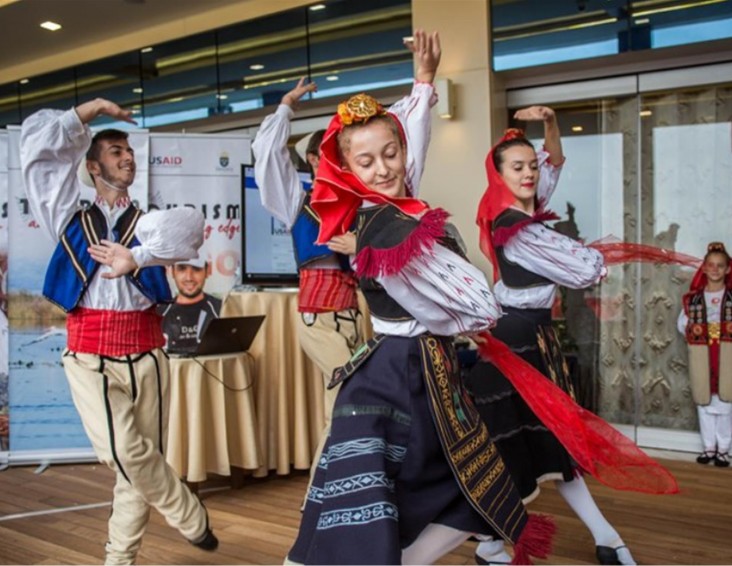 Traditional Albanian dancing troupe performing at a tourism development event.