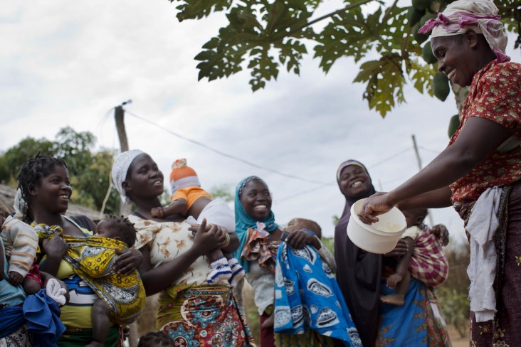 A community health worker, who has received USAID training, carries out a weekly nutritional cooking class at a community member's house in Nampula, Mozambique. Women with newborn babies are encouraged to attend so they learn about nutrition and the types of food their babies need to be weaned onto.