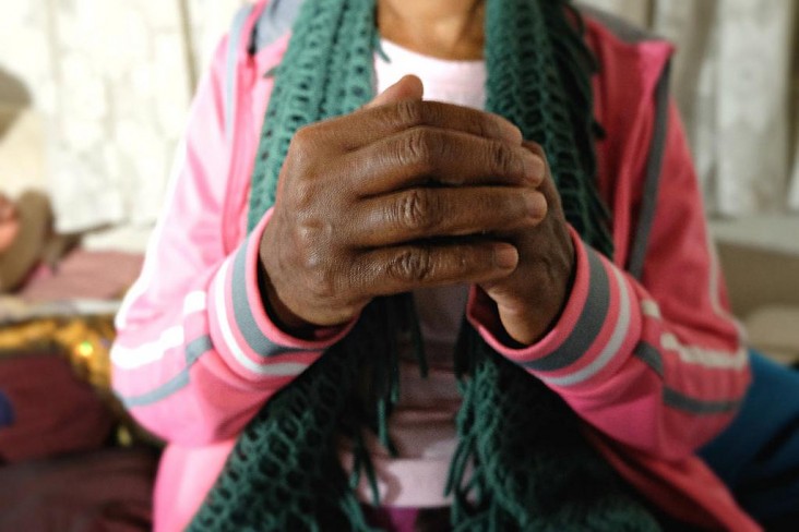 A close-up photo of clasped hands. USAID works with partners around the globe to provide HIV/AIDS care and treatment that is free from stigma and discrimination.