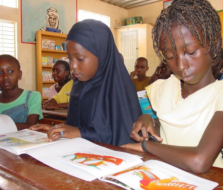 Two female students reading textbooks in a Senegalese school 
