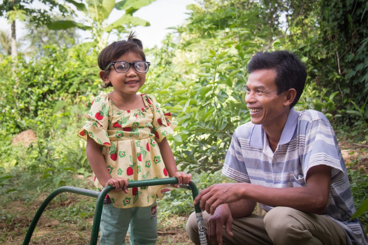 With USAID/Cambodia’s support, the Family Care First network provided three-year-old Sreyna with glasses and a walking frame to help her see and learn to walk. Now Sreyna can play happily with other children and her father, Samnang, said “I now have a new hope for my daughter.”