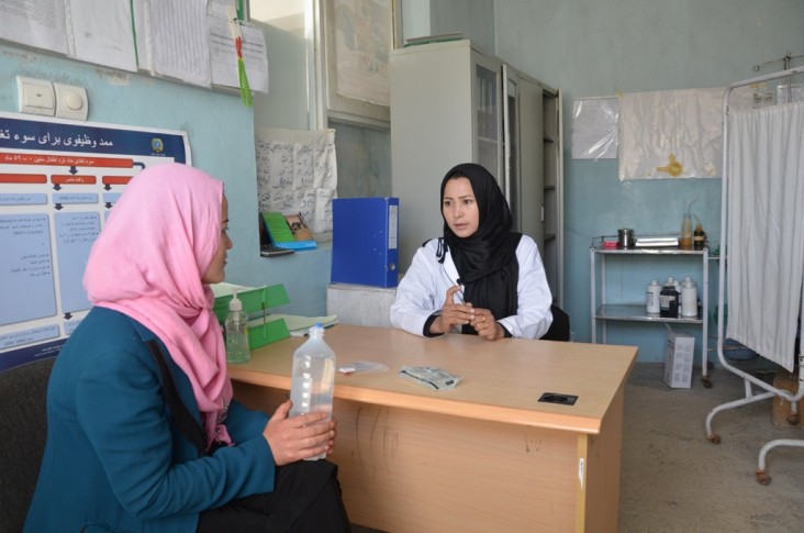 A health worker sits with a patient to assess what’s the best course of action.