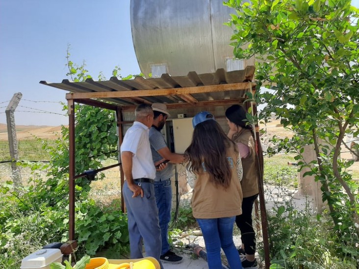 Engineers conduct assessments on farms' water pumps that will be powered through solar energy.