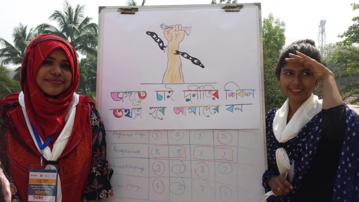 Bangladesh: Two women holding up poster