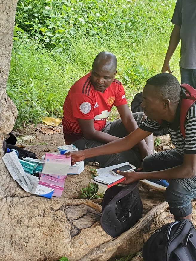Baxton Kamanga (right) reviewing the contents of the drone. / Ryan Triche, GHSC-PSM