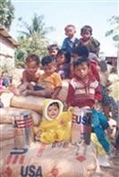 Cambodian refugees receive USAID-provided food assistance in the early 1990s.