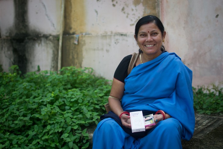 An Indian woman displays medication
