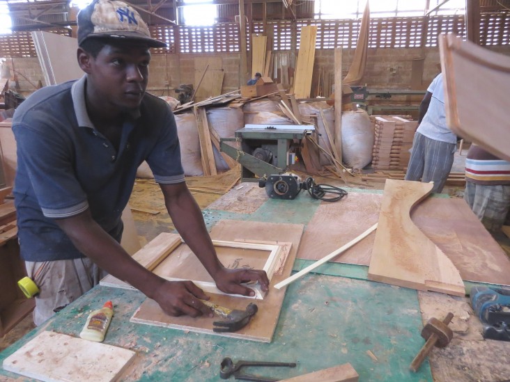 Byron Ettienne, 20, is hard at work learning the wood trade.