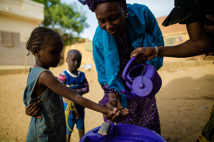 Hapsatou Ka is a USAID-trained, community-based solution provider in Senegal. She teaches local children the importance of sanitation by washing their hands prior to eating lunch.