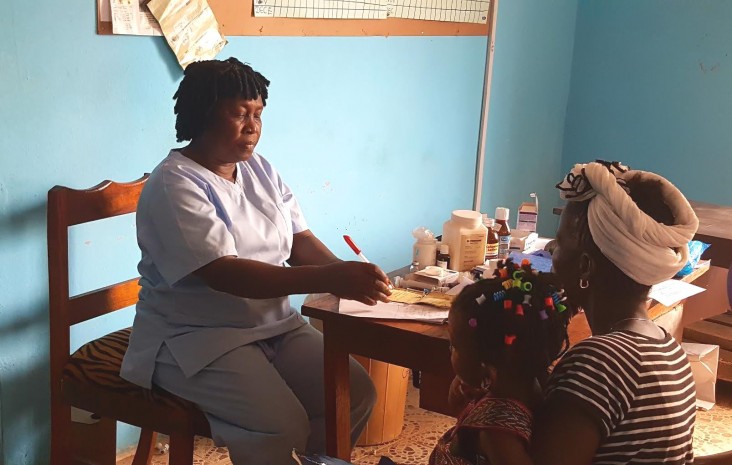 Elizabeth Coker (Nurse Betty) registers a patient at her maternal and child health post, Freetown, Sierra Leone.