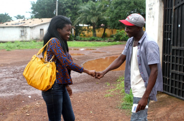 Mariama Keita and Alseny Touré greet each other at the French Red Cross site near the Ebola Treatment Unit in Forécariah, Guinea