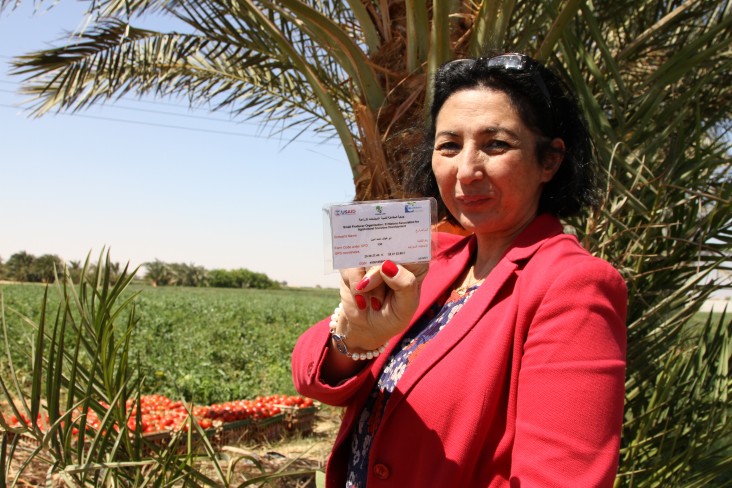 Manal Saleh, general manager of Blue Moon, shows a tag signifying that this tomato field adheres to GlobalGAP and Fairtrade standards.