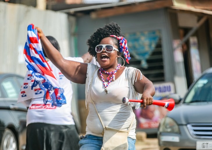 A jubilant Ghanaian woman wearing the colors of the victorious New Patriotic Party celebrated in the street after the election results were announced.