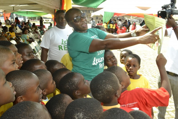 Janet Awokoya, a school report card specialist, interacts with children during the reading festival in Kumasi.