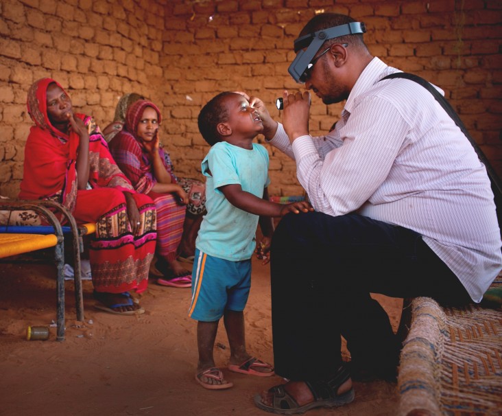 Anwar is examined by a doctor from Sightsavers.