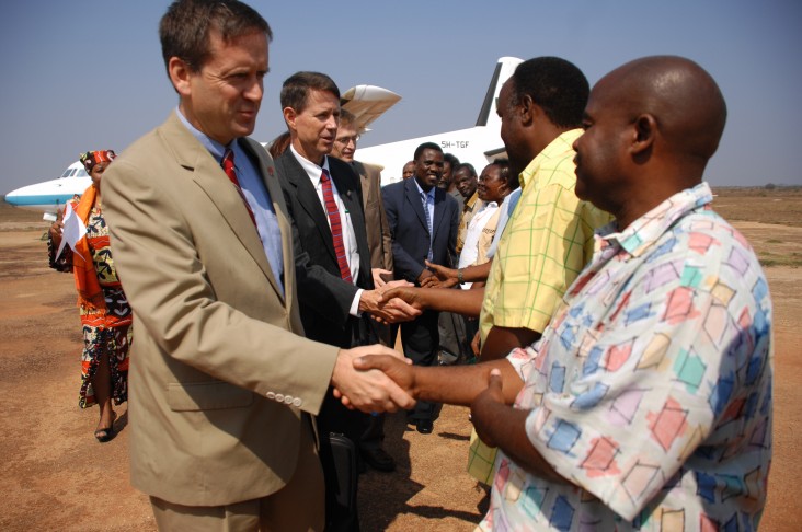 Ambassador Mark Green and Paul Monger, chief of staff for the Combined Joint Task Force-Horn of Africa, are greeted by Tanzania’s ministers and staff after landing in Lindi in September 2008.