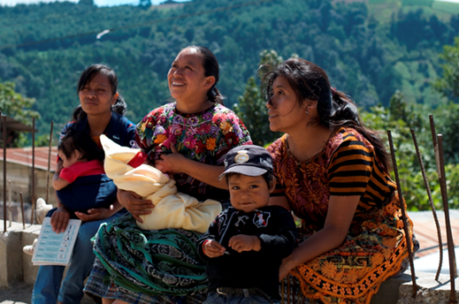 Mothers sit with their young children during a breastfeeding training at a local health center in Guatemala.